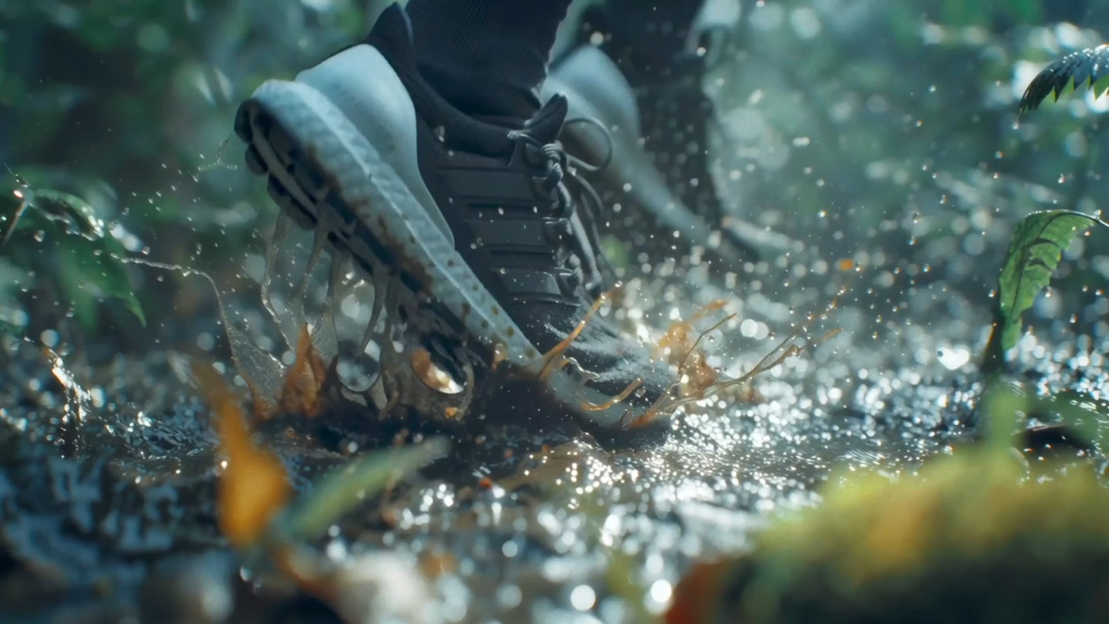 A running shoe striking through backlit mud