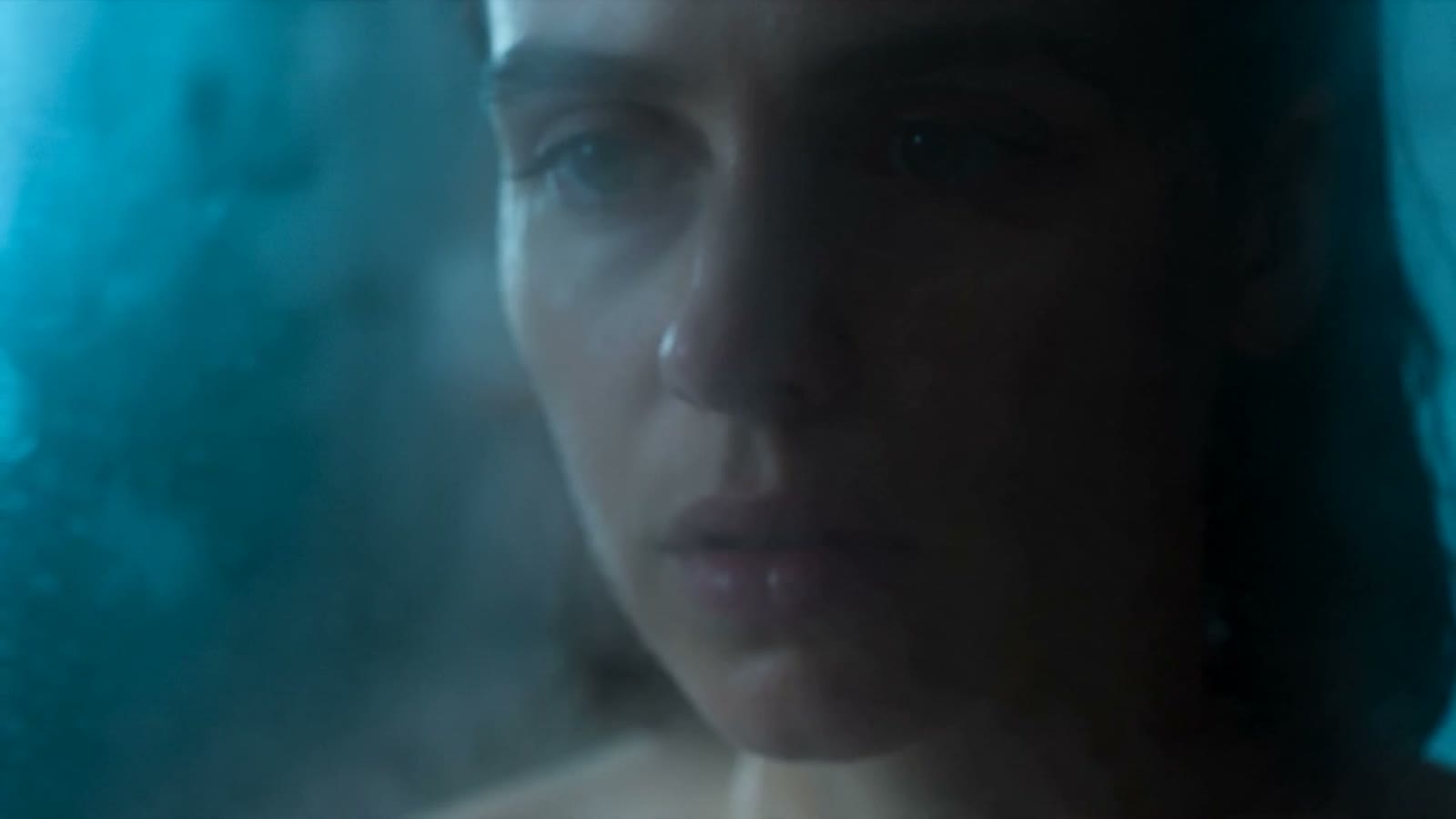 A face emerging through steam and wet glass