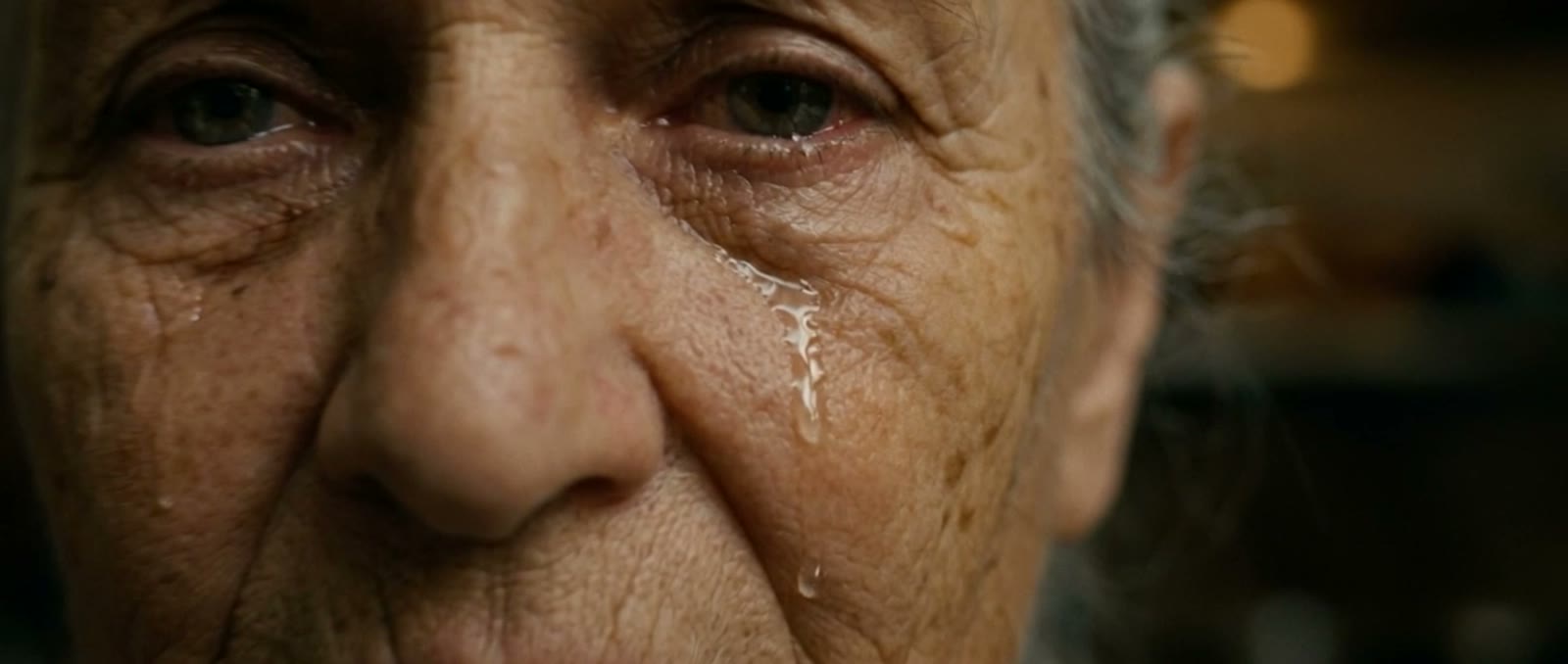The nonna's face, one tear on her cheek