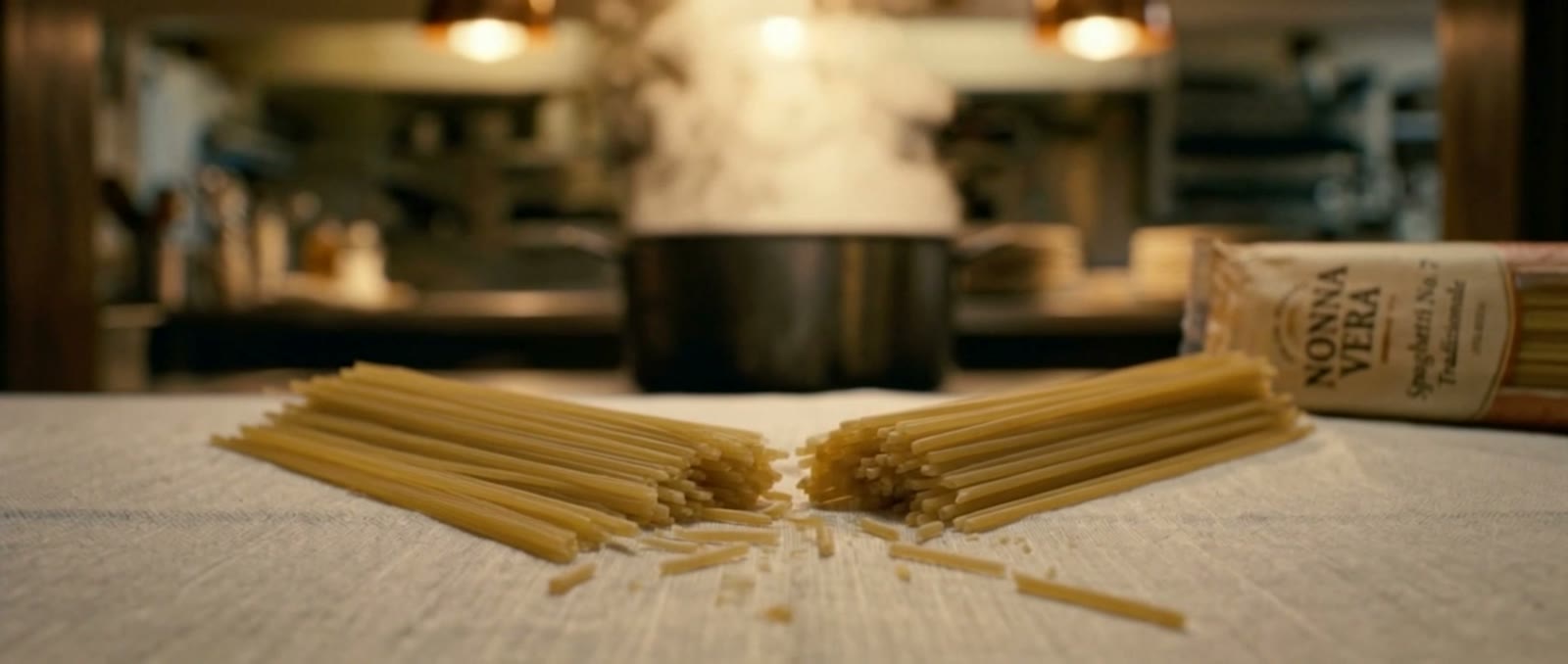Dry spaghetti split in two on linen
