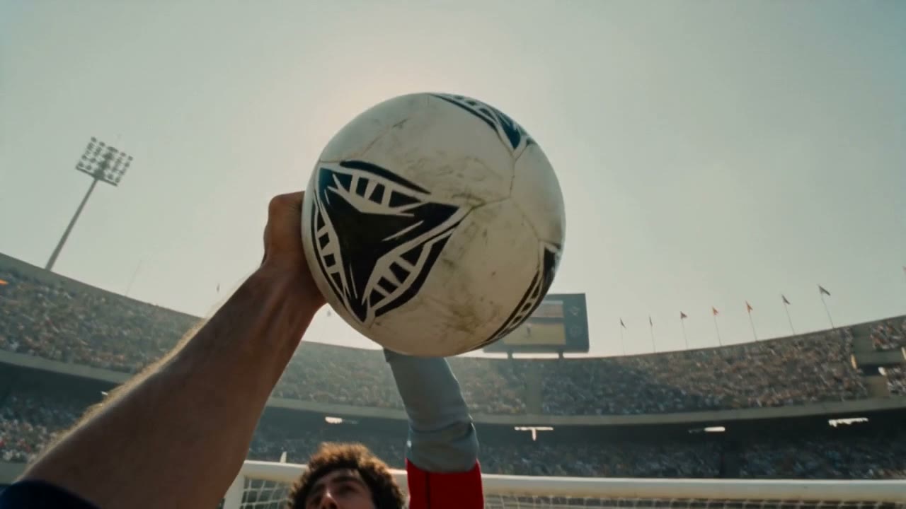 Point of view: a raised fist meets the ball in the air above the keeper