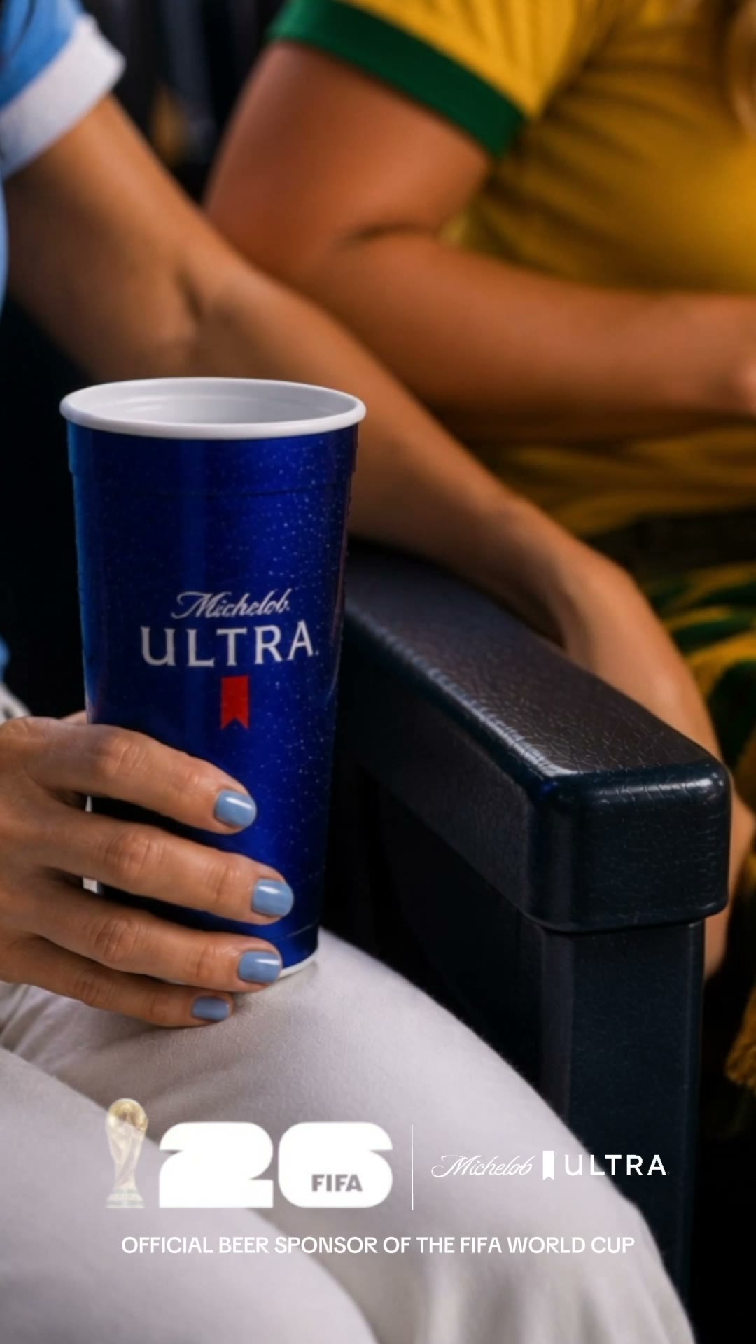 A Michelob Ultra cup held on the armrest