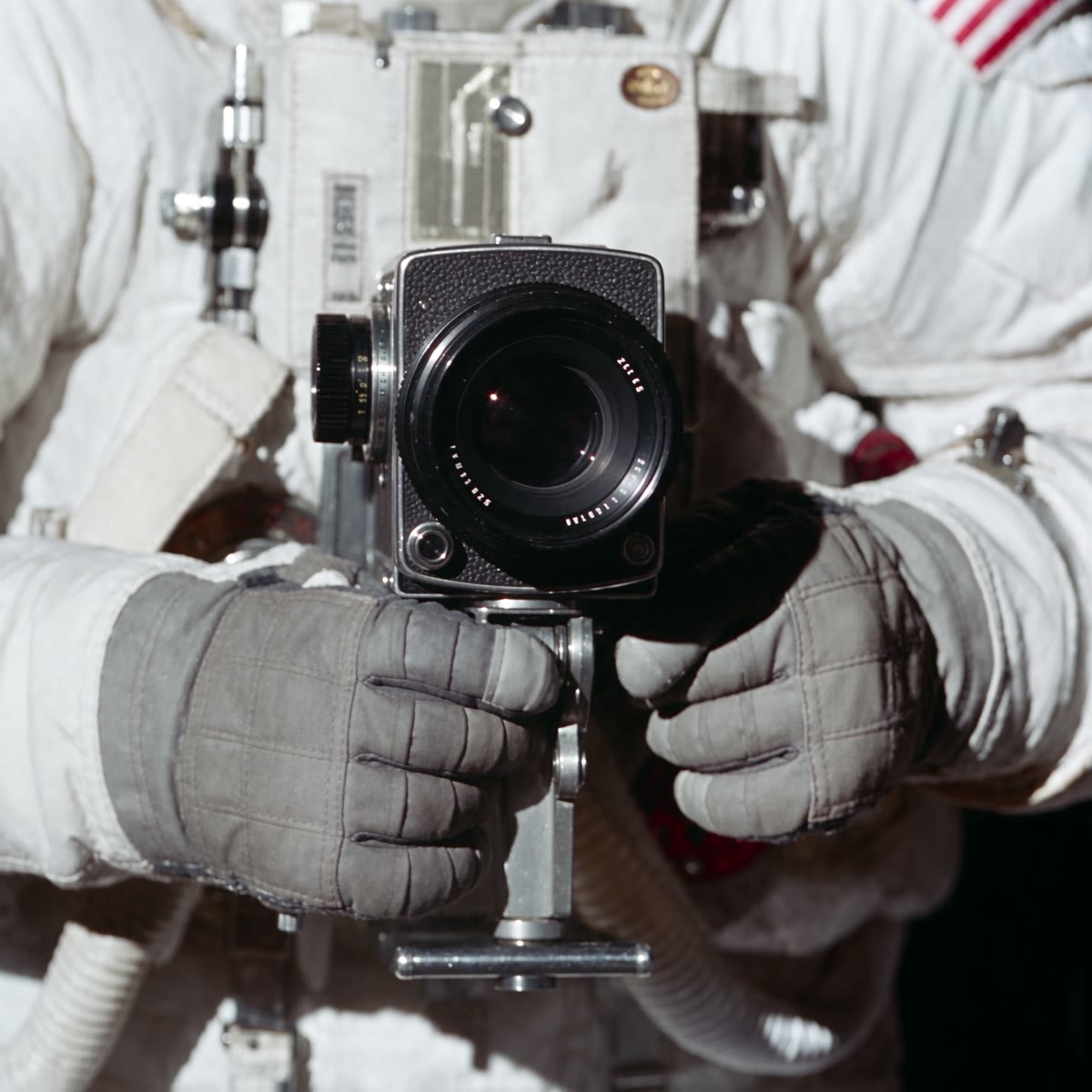 The Hasselblad held in gloved hands