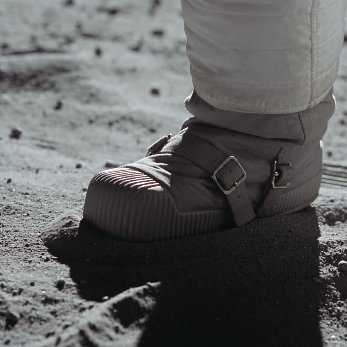 A boot pressed into the regolith