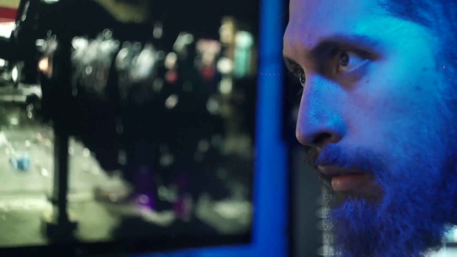 The protagonist's profile in blue monitor light