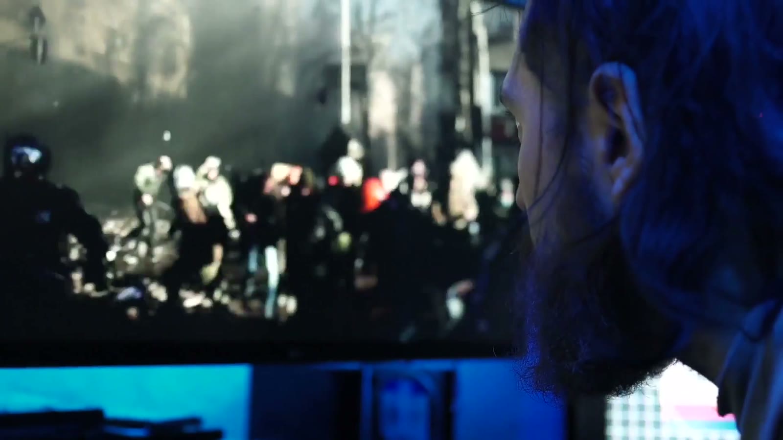 Over the shoulder: conflict footage replayed on screen